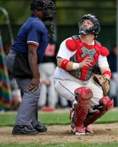 Image of a catcher tracking a high pop fly going foul.