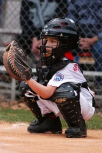 Youth 12U Catcher Wearing Rawlings Mitt Framing a Pitch