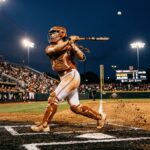Reese Atwood finishing a powerful swing from behind home plate